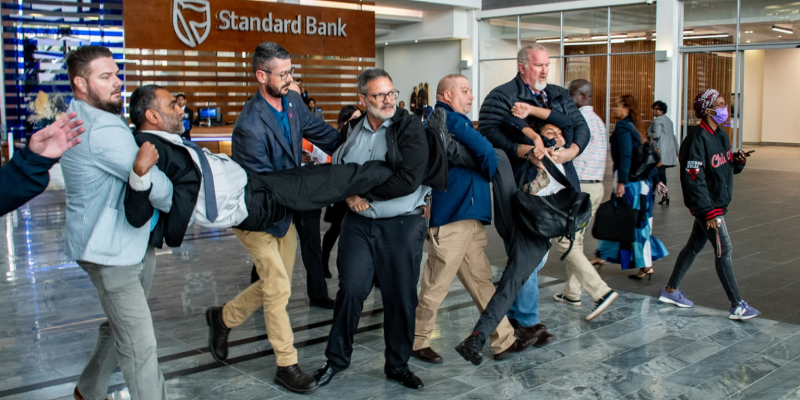 Kumi Naidoo forcibly removed from Standard Bank HQ after protest over crude oil pipeline project (By Julia Evans)