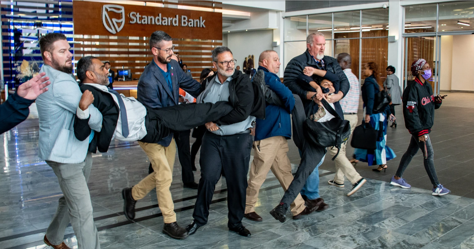 Kumi Naidoo forcibly removed from Standard Bank HQ after protest over crude oil pipeline project (By Julia Evans)